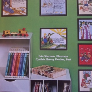 Peut inclure: Une présentation du livre "Christian Nursery Rhymes Book" avec des illustrations de comptines. L'affichage comprend un ensemble de livres colorés, un train jouet et des blocs alphabétiques. Le livre est de Stirrup Associates.