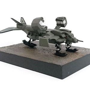 May include: A white ceramic mug with a black handle and the text "But first, coffee" in a handwritten style. The mug is on a white surface. The mug is 4 inches tall.