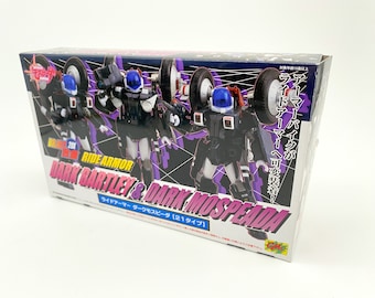 May include: A box for a toy robot set featuring two black and white robots with blue helmets. The box has a purple and pink background with the text "Ride Armor Dark Bartley & Dark Mospeada" and "ライドアーマー ダークモスピーダ [21タイプ]" in Japanese.