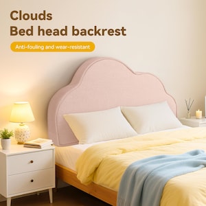 May include: A pink cloud-shaped bed head backrest. The headboard is upholstered and sits above a bed with white pillows, a yellow comforter, and a blue blanket. The text on the image reads "Clouds Bed head backrest" and "Anti-fouling and wear-resistant."