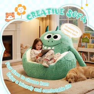 May include: A large, green monster-shaped sofa with a smiling face and horns. A young girl sits on the sofa, holding a tablet. The sofa is on a light-coloured rug, with a sleeping golden retriever nearby. Text on the image reads "CREATIVE SOFA".