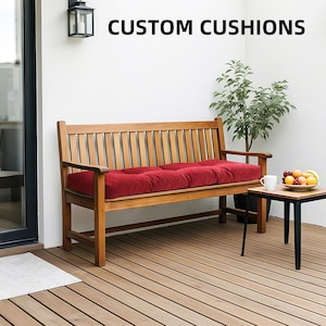 May include: A wooden bench with a red cushion on the seat. The bench is on a wooden deck and there is a small table with a cup and fruit on it. The text "CUSTOM CUSHIONS" is at the top of the image.