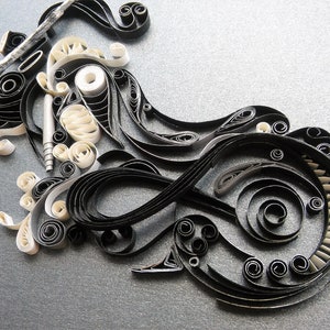 May include: Black and white paper quilling art, featuring intricate swirls and patterns. The design resembles a stylised motorcycle.