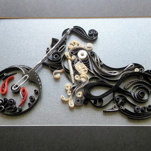 May include: A black and white paper quilling artwork depicting a motorcycle. The motorcycle is framed in a black frame with a grey mount.