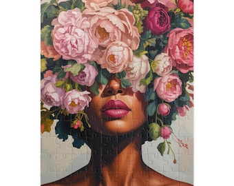 May include: A rectangular jigsaw puzzle featuring a portrait of a person with a floral headpiece. The flowers are various shades of pink, with green foliage. The person's skin is brown, and the lips are a deep pink.