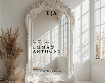 May include: A large, ornate white wedding sign with the text "WELCOME TO THE WEDDING OF EMMA & ANTHONY" and the date "20 SEPTEMBER 2024". The sign has a decorative, arched top and is placed in a bright, sunlit room.