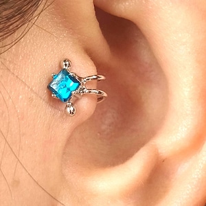 Tragusörhänge i vitt guld: Indicolitblå Swarovski-kristall, utan piercing