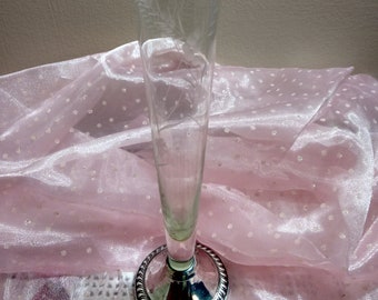 May include: A clear glass bud vase with an etched floral design and a silver base.