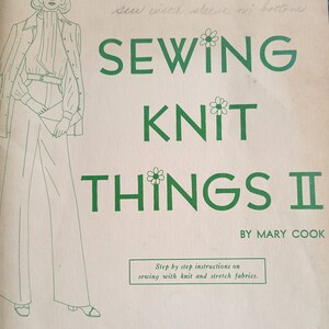 May include: Vintage sewing pattern titled "SEWING KNIT THINGS II" by Mary Cook. The cover features a green illustration of a woman in a suit and the text "HEMS & HERS Inc."