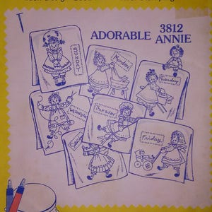 May include: A vintage craft pattern for iron-on transfers featuring a series of adorable dolls representing each day of the week. The pattern is titled "Adorable Annie" and is number 3812. The pattern is for embroidery, textile painting, needlepoint canvas, and other art crafts.