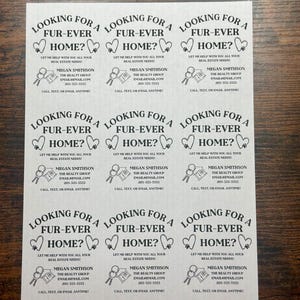 May include: Nine black and white business cards with a paw print and heart design. The text on the cards reads "Looking for a Fur-Ever Home? Let me help with you all your real estate needs! Megan Smithson The Realty Group Email@email.com 205-555-5555 Call, Text, or Email Anytime!"