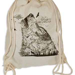 Könnte beinhalten: Eine weiße Kordeltasche mit einer Schwarzweißillustration eines Wolfes, der zum Mond heult. Der Wolf ist von Bergen und Bäumen umgeben. Die Tasche hat eine weiße Kordel.