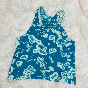 May include: A blue and white tie-dye tank top with a small logo on the bottom right corner.