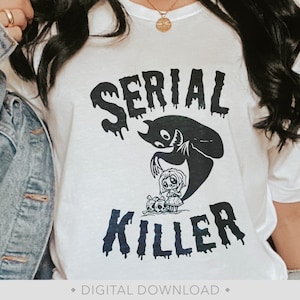 May include: White t-shirt with black text that reads "SERIAL KILLER" with a dripping effect. A black silhouette of a ghost holding a doll is above the text. "DIGITAL DOWNLOAD" is written in black at the bottom of the shirt.