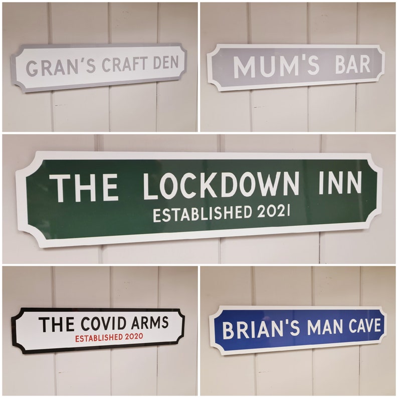 May include: Five different signs with white lettering on a colored background. The signs are all in the style of street signs. The signs read: "Gran's Craft Den", "Mum's Bar", "The Lockdown Inn Established 2021", "The Covid Arms Established 2020", and "Brian's Man Cave".