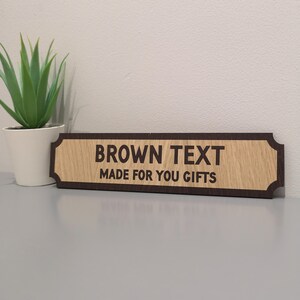 May include: A wooden sign with a brown border and the text "BROWN TEXT MADE FOR YOU GIFTS" in brown lettering.