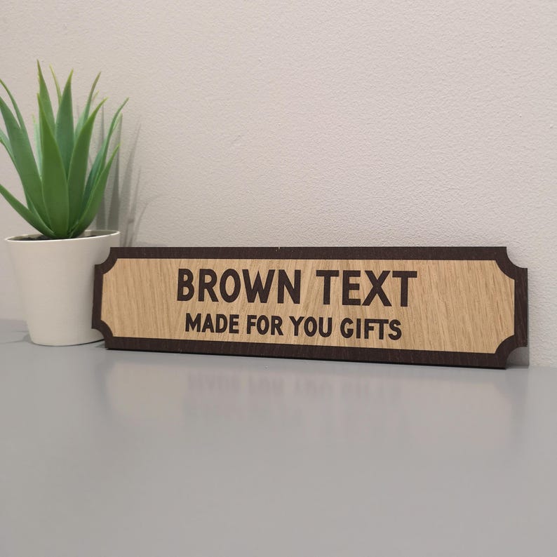 May include: A wooden sign with a brown border and the text "BROWN TEXT MADE FOR YOU GIFTS" in brown lettering.
