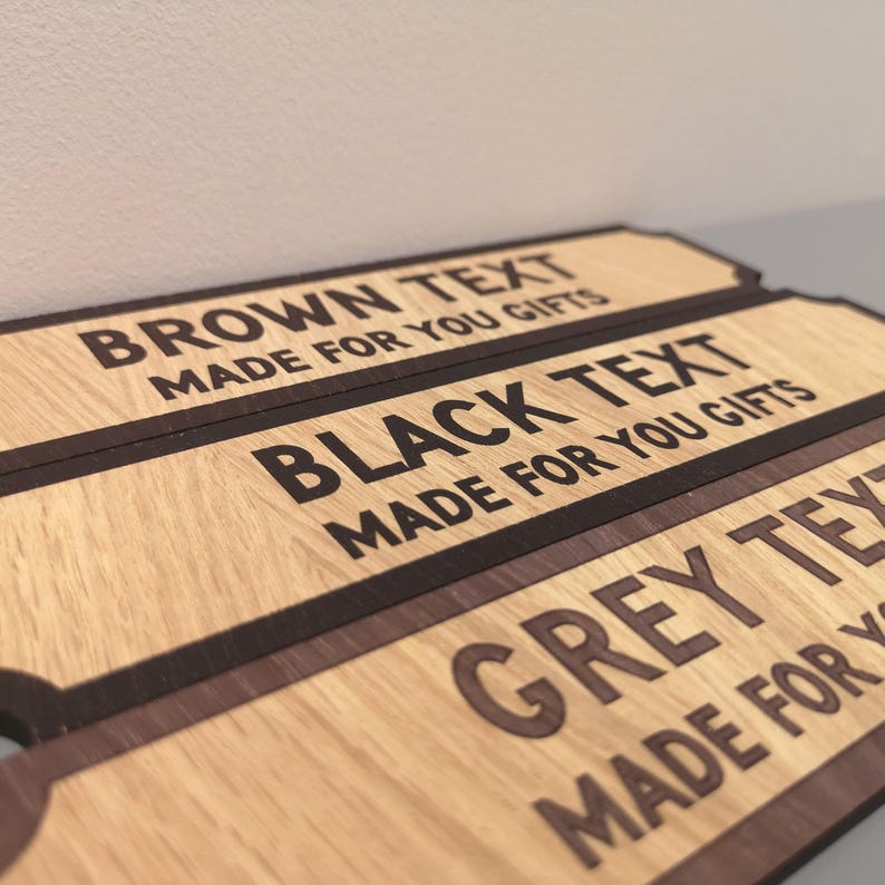May include: Three wooden signs with a dark brown border. The top sign reads "BROWN TEXT MADE FOR YOU GIFTS". The middle sign reads "BLACK TEXT MADE FOR YOU GIFTS". The bottom sign reads "GREY TEXT MADE FOR YOU GIFTS".