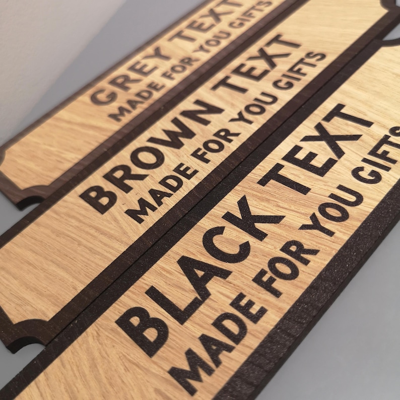May include: Three wooden signs with black text on them. The top sign says "GREY TEXT MADE FOR YOU GIFTS". The middle sign says "BROWN TEXT MADE FOR YOU GIFTS". The bottom sign says "BLACK TEXT MADE FOR YOU GIFTS".