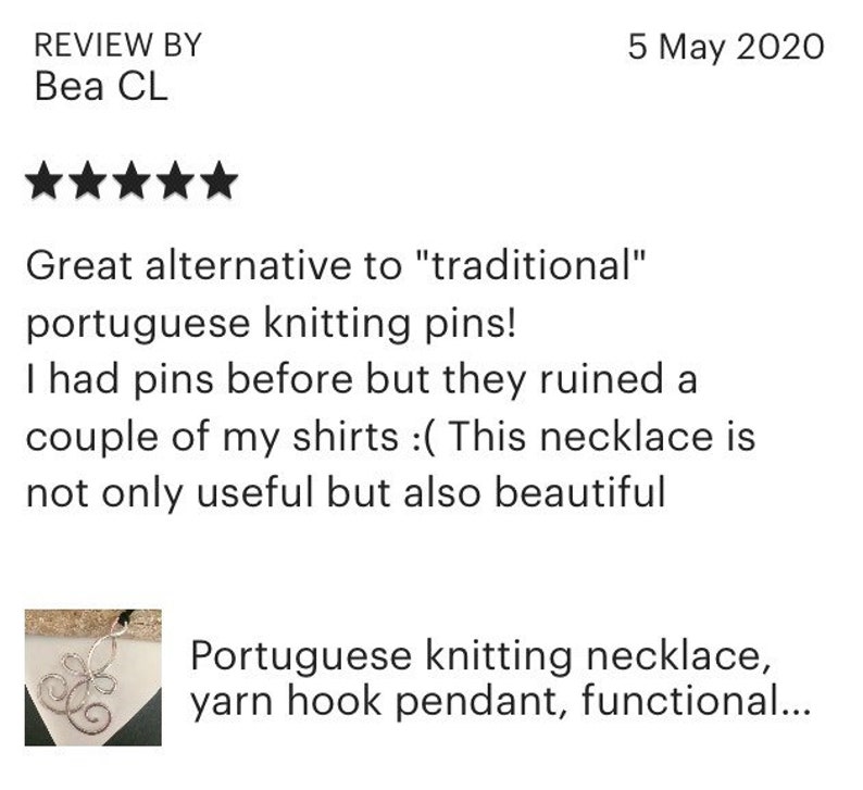 May include: A silver knitting needle necklace with a decorative swirl design. The necklace is a functional alternative to traditional knitting needles. The product description reads "Portuguese knitting necklace, yarn hook pendant, functional..."