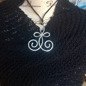 Portuguese knitting necklace on model worn high up for knitting