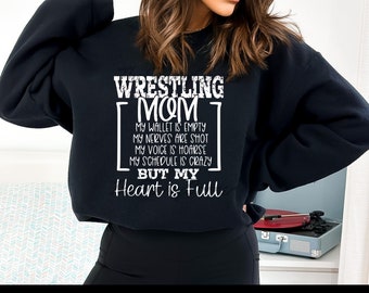 May include: Black sweatshirt with white text that reads "Wrestling Mom" and "My wallet is empty, my nerves are shot, my voice is hoarse, my schedule is crazy, but my heart is full."