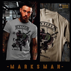 May include: A grey t-shirt featuring a graphic of a skull with a snake wrapped around it. The graphic includes the text "Sniper", "One Shot", "One Kill", "Deadly", and "Accuracy".