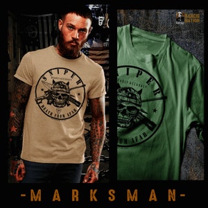 May include: A tan and green t-shirt with a skull and crossbones graphic. The graphic says "Sniper Deadly Accuracy Death From Afar".