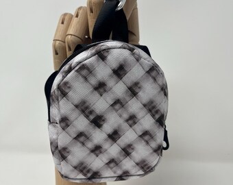 Tiny black plaid backpack keychain holds cards, keys, change, chapstick, iPods, etc. Attaches to backpack or belt loops with carabiner