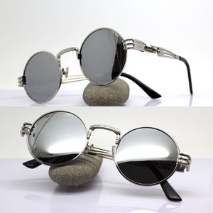 K&ouml;nnte beinhalten: Silberne runde Sonnenbrille mit verspiegelten Gl&auml;sern und einem einzigartigen, filigranen Metallrahmen-Design.