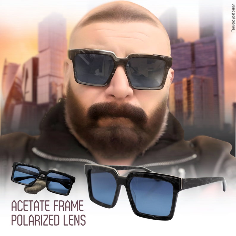 May include: A pair of black acetate sunglasses with polarized lenses. The sunglasses have a square frame with a dark blue lens. The text "ACETATE FRAME POLARIZED LENS" is printed below the sunglasses.