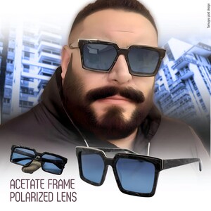 May include: A pair of black acetate sunglasses with polarized lenses. The sunglasses have a square frame with a marble-like pattern. The lenses are blue.