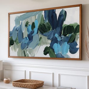 May include: Abstract painting with blue, green, and white brushstrokes. The painting is framed in a natural wood frame.
