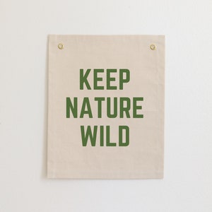 May include: A beige canvas wall tapestry with the text "KEEP NATURE WILD" printed in dark green.