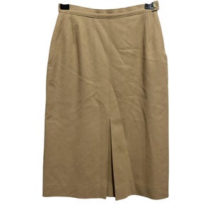 May include: A brown knee-length skirt with a front slit and a gold button at the waist.