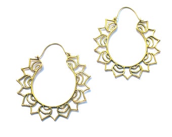 May include: A pair of gold-toned hoop earrings with a decorative mandala design.