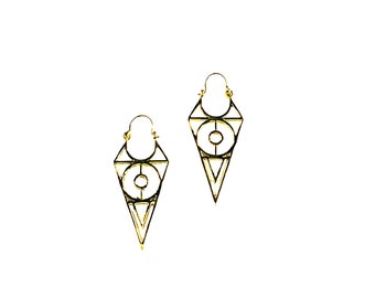 May include: A pair of gold geometric earrings with a triangle shape and a circle in the center.