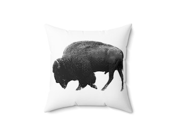 May include: A black and white throw pillow with a graphic of a buffalo. The buffalo is facing left and is in a running pose.