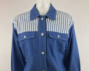 May include: A blue denim shirt with a white and blue striped yoke. The shirt has a button-up front and long sleeves.
