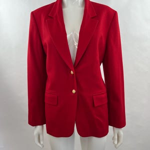 May include: A vibrant red blazer with a classic design. The blazer features a notched lapel, two front pockets, and gold-colored buttons. The tailored fit and bold color make it a statement piece.