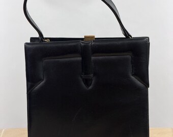 Bolso de mano vintage Viki original de cuero negro de los años 50 y 60, estilo Kelly, estructurado, con asa superior y forro color crema. Bolso clásico tipo cartera.
