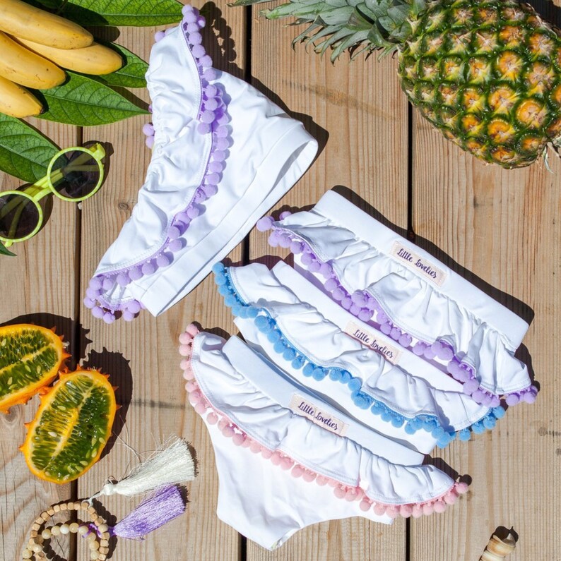 White swimsuit for girls with lavender pom poms,swimsuit girls,one piece swimsuit,toddler girl swimsuit,bikini bottoms,white baby swimsuit
