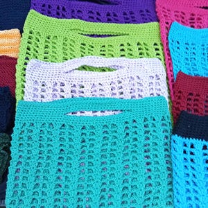 May include: A white ceramic mug with a black handle and the text "But First, Coffee" in a black, handwritten-style font. The mug is on a white surface.