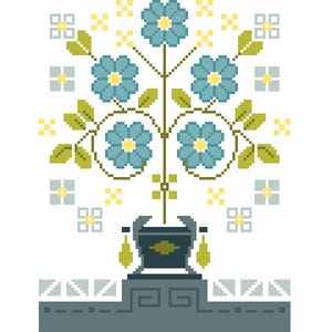 May include: A cross-stitch pattern featuring a central dark blue urn with two hanging yellow tassels, topped with a symmetrical arrangement of five blue flowers with yellow centres, green leaves, and small yellow and light blue geometric accents.