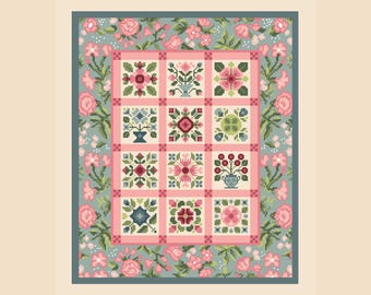 May include: A cross-stitch pattern featuring a grid of twelve square blocks, each displaying unique floral motifs in shades of pink, green, and blue. The central grid is framed by a wide border decorated with pink roses and green foliage on a blue background.