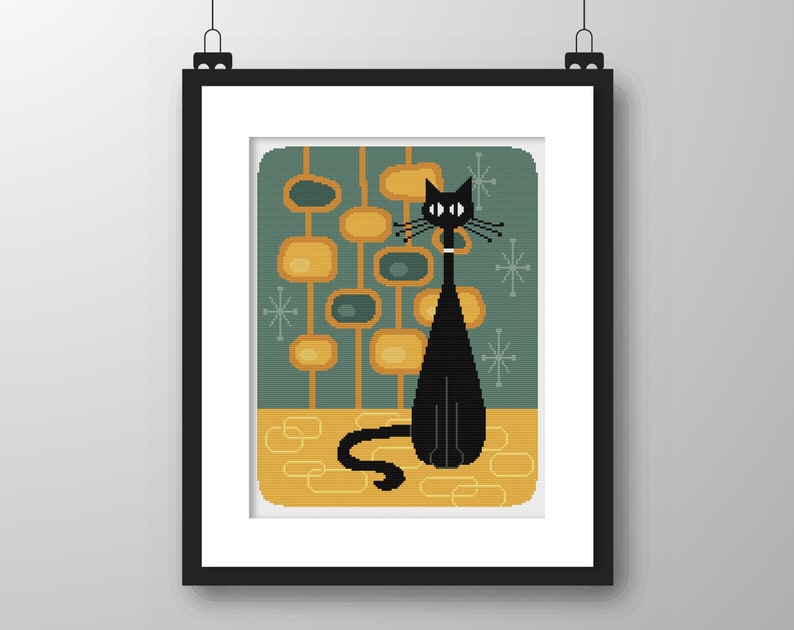 May include: A black cat with large eyes sits in front of a teal and yellow geometric pattern. The cat has a white collar and is looking to the right.