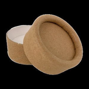 May include: A light brown, round cardboard box with a lid. The lid is slightly open, revealing the white interior. The box is made of a textured material. The box is designed to be a container.