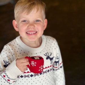 Little boy holding Hot Chocolate Christmas Ornament from Ornaments 4 Orphans.