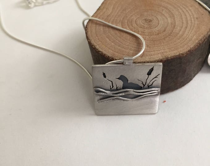 small, square, sterling silver loon pendant