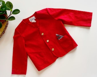 May include: A vibrant red jacket with long sleeves, three gold buttons, and a small plaid pocket square. The jacket has a rounded collar and two front pockets. The tag reads "Good Look".